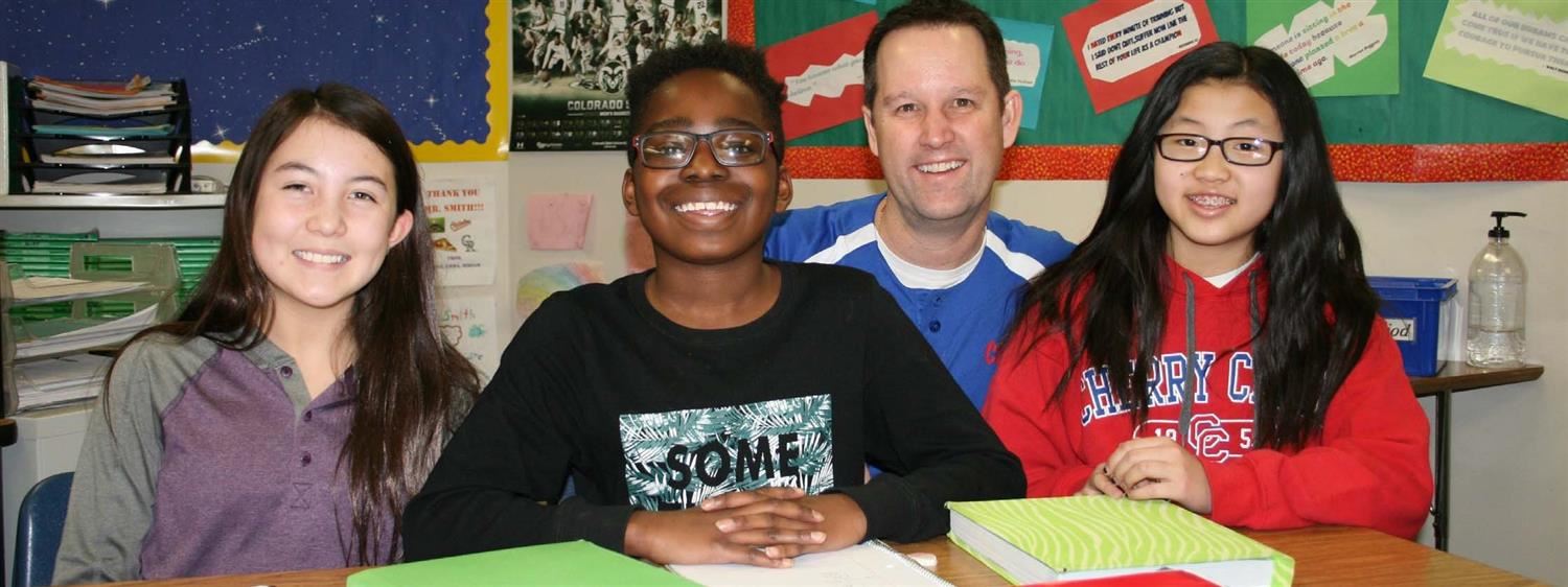 Middle School Students with Teacher smiling 